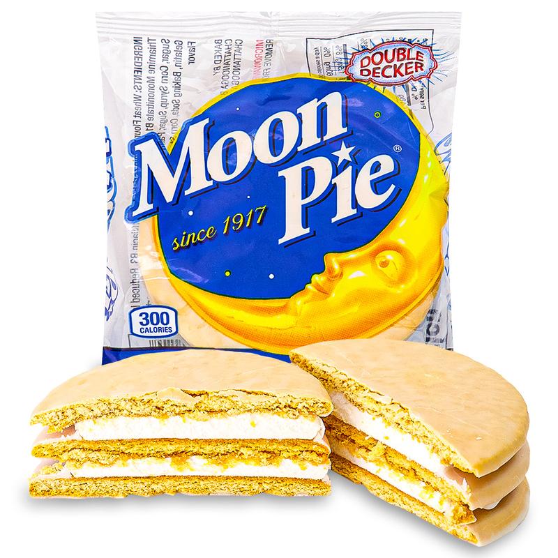 Un emballage transparent avec une lune jaune dans un ciel bleu et écrit «Vanilla » sur fond bleu et devant 2 gâteaux coupés en 2